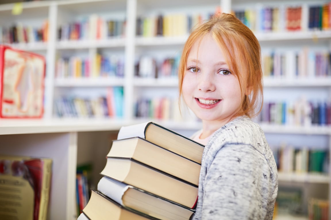 Schoolgirl with a Stack of Books to Borrow